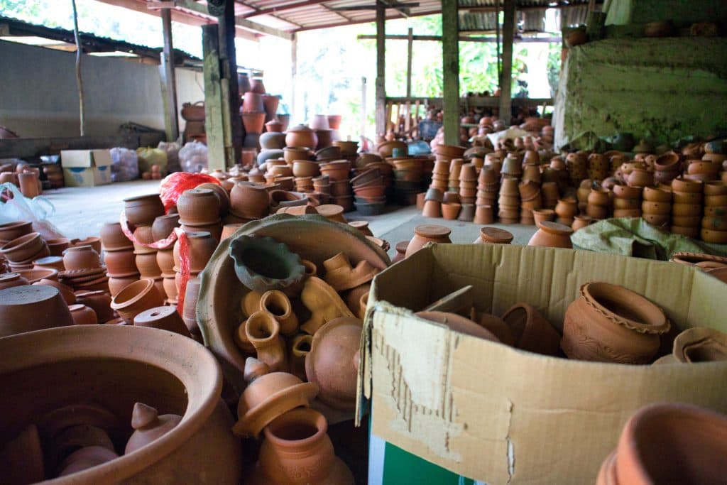 pottery bowls and cups laying in a pile, in a box, on koh kret island in bangkok.